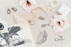 Silver Jewelry on the Table Among Flowers